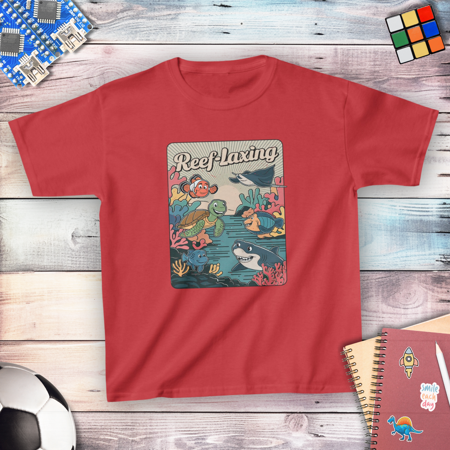 Kids' STEM T-shirt in red, Reef-Laxing coral reef design with turtle, clownfish and shark
